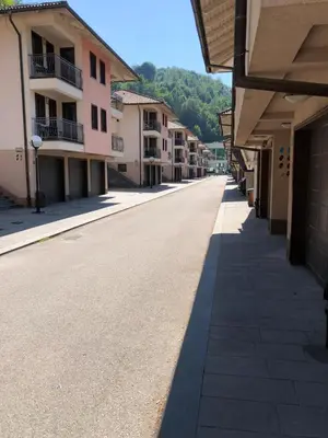 an empty street in a town with buildings at Street View Apartman in Fojnica