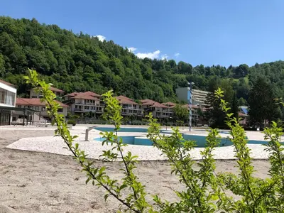 a swimming pool in front of a resort at Street View Apartman in Fojnica