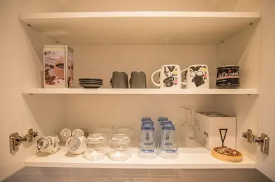 a shelf with bottles and other items on it at Jelena Apartment II in Doboj