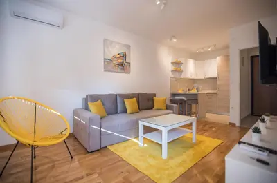 a living room with a couch and a table at Jelena Apartment II in Doboj