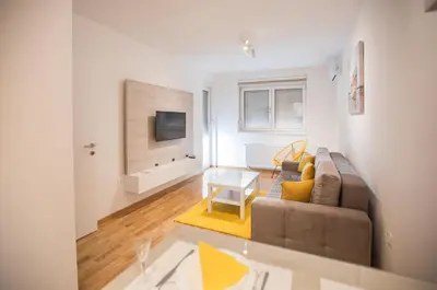 a living room with a couch and a table at Jelena Apartment II in Doboj