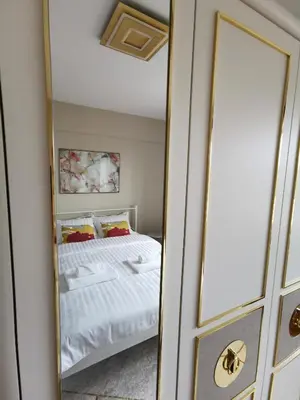 a mirror reflecting a bed in a bedroom at Luxury Apartment with a stunning view, FREE parking in Tuzla