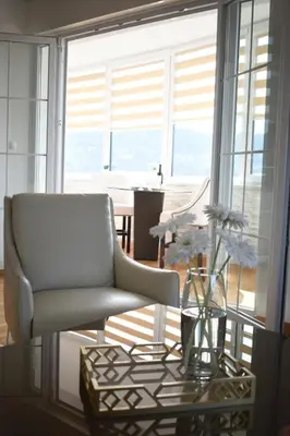 a living room with a chair and a table at Luxury Apartment with a stunning view, FREE parking in Tuzla