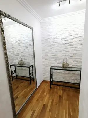 a mirror in a room with a bench and a table at Luxury Apartment with a stunning view, FREE parking in Tuzla