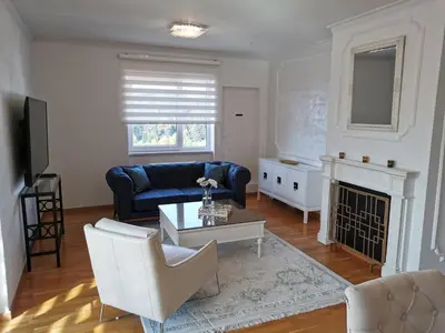 a living room with a blue couch and a fireplace at Luxury Apartment with a stunning view, FREE parking in Tuzla