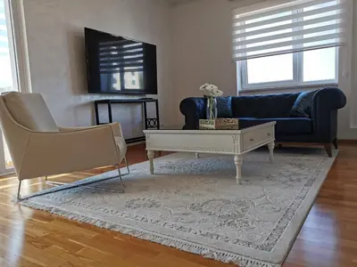 a living room with a couch and a coffee table at Luxury Apartment with a stunning view, FREE parking in Tuzla