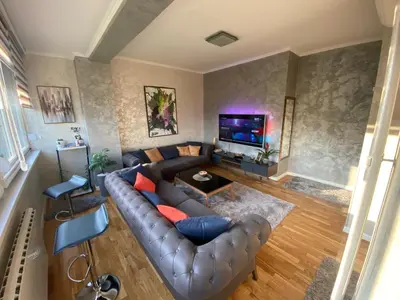 an overhead view of a living room with a leather couch at Apartman 