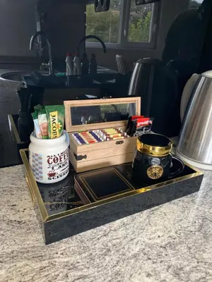 a tray with a box and other items on a counter at Apartman 