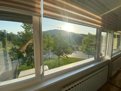 a window with a view of a street at Apartman 