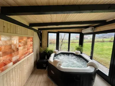 a large bath tub in a room with windows at Residence Wood Pool & SPA in Visoko