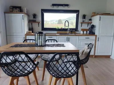 a kitchen with a table and chairs and a sink at Residence Wood Pool & SPA in Visoko