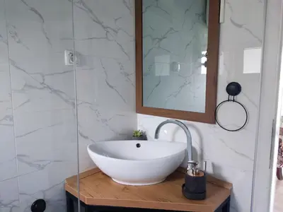 a bathroom with a white bowl sink and a mirror at Residence Wood Pool & SPA in Visoko