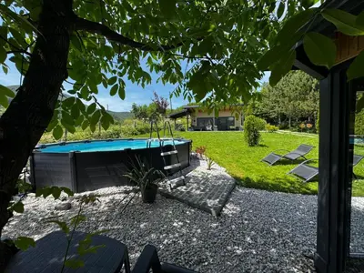 a backyard with a swimming pool and a house at Residence Wood Pool & SPA in Visoko