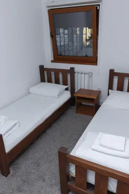 two beds in a room with a window at Pansion A&M Vlašić in Vlasic