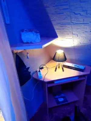a desk with a lamp on it in a room at Pyramid in Visoko