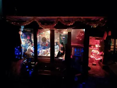 a group of people standing in a store at night at Pyramid in Visoko