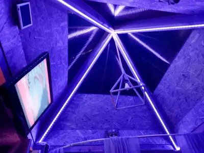 a room with purple lights on the ceiling and a tv at Pyramid in Visoko