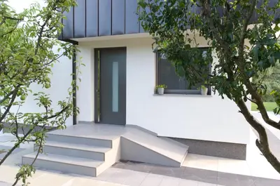 a house with stairs leading up to a door at Villa Una Sunset in Bihać