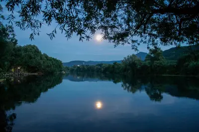 a view of a river at night at Villa Una Sunset in Bihać