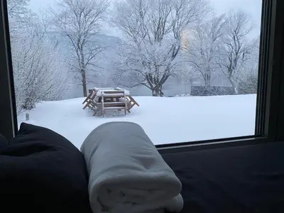 a view of a snow covered yard from a window at Villa Una Sunset in Bihać