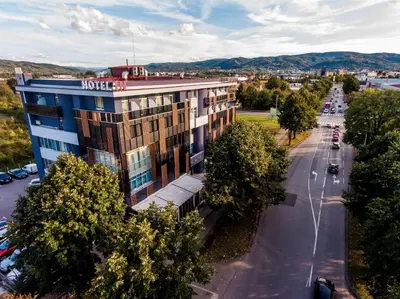 a building with a motel sign on the side of a street at Hotel IN in Banja Luka