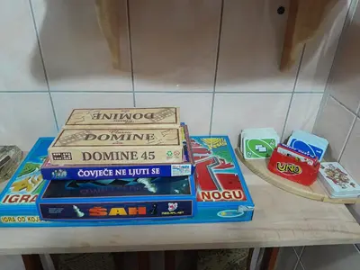 a stack of books sitting on a table at Dolores in Tešanj