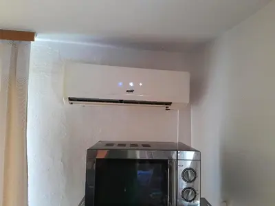 a microwave sitting in a room with a stove at Dolores in Tešanj