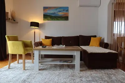 a living room with a couch and a table at The View Apartment in Visoko