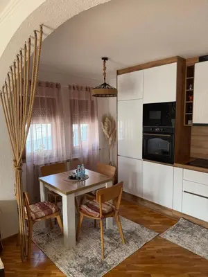 a kitchen with a table and chairs in a room at The View Apartment in Visoko