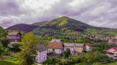 a village in front of a mountain at The View Apartment in Visoko