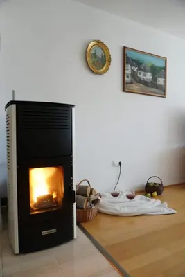 a fireplace sitting on the floor in a living room at Apartman Perunika in Kupres