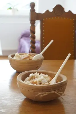 two bowls of food sitting on a wooden table at Apartman Perunika in Kupres