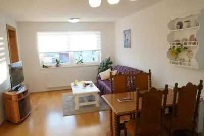 a living room with a couch and a table at Apartman Perunika in Kupres
