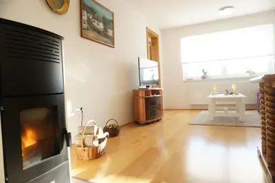 a living room with a fireplace and a television at Apartman Perunika in Kupres