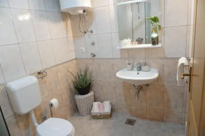 a bathroom with a toilet and a sink at Apartman Perunika in Kupres