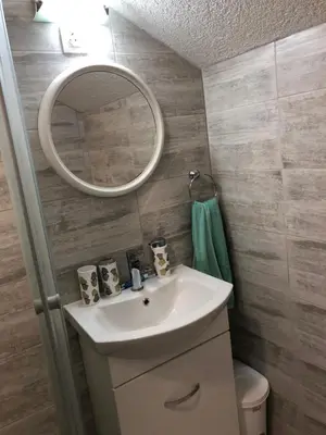a bathroom with a sink and a mirror at Apartmani Kaić in Livno