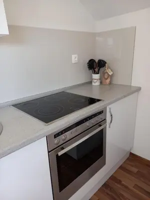 a kitchen with a stove and a counter top at Apartmani Kaić in Livno