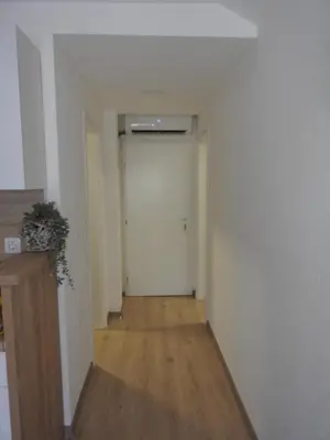 an empty room with a hallway with a door at Apartmani Kaić in Livno