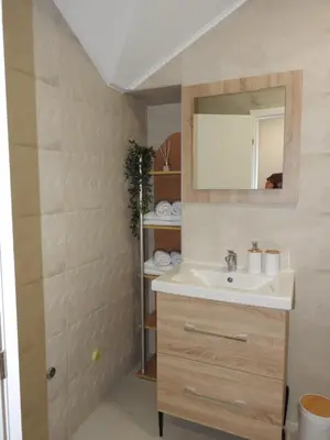 a bathroom with a sink and a mirror at Apartmani Kaić in Livno