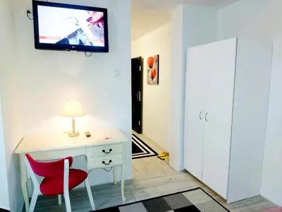 a room with a desk and a tv on the wall at APARTMAN ANDREA 4 in Banja Luka