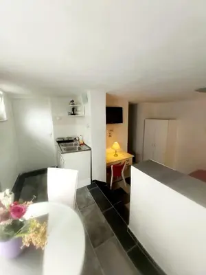 a small room with a kitchen and a table at APARTMAN ANDREA 4 in Banja Luka