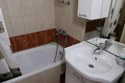 a bathroom with a sink and a toilet and a tub at Apartman UNA Travnik in Travnik