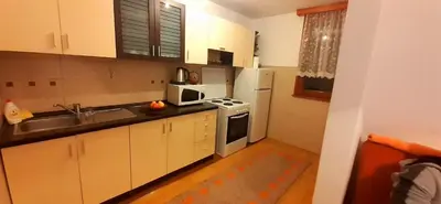 a small kitchen with a sink and a refrigerator at Apartman UNA Travnik in Travnik