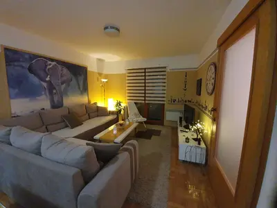 a living room with a couch and a table at Apartman Lari in Vlasic