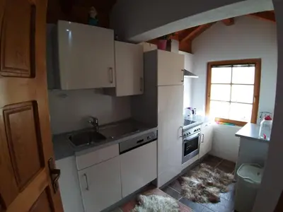 a kitchen with white cabinets and a sink and a window at COUNTRY HOUSE in Bihać