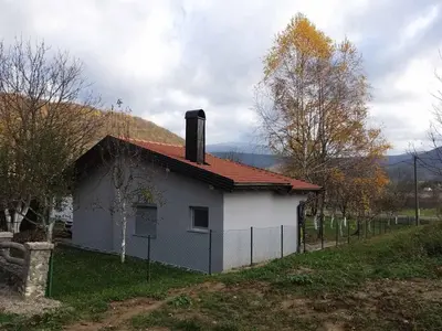 a small white house with a red roof at COUNTRY HOUSE in Bihać