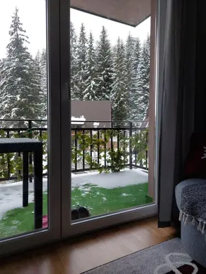 a window with a view of a snow covered yard at Apartman Zlaja Vlašić in Vlasic
