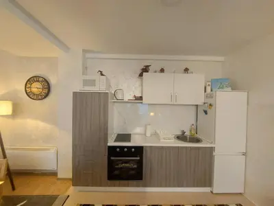 a small kitchen with white cabinets and a sink at Apartman Zlaja Vlašić in Vlasic