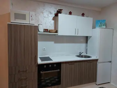 a small kitchen with a sink and a microwave at Apartman Zlaja Vlašić in Vlasic