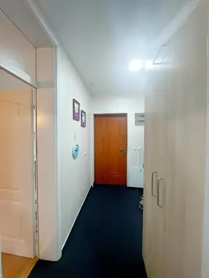 a hallway with a wooden door and a hallway sidx sidx at Apartman Zlaja Vlašić in Vlasic